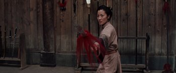 Movie still from “Crouching Tiger, Hidden Dragon” (2000), directed by Ang Lee – A woman is holding a knife in her hand; Medium shot, Low angle