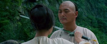 Movie still from “Crouching Tiger, Hidden Dragon” (2000), directed by Ang Lee – A man and a woman are cutting their hair; Close Up shot, Over the shoulder angle