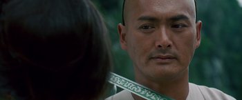 Movie still from “Crouching Tiger, Hidden Dragon” (2000), directed by Ang Lee – A person wearing a neck tie; Close Up shot, Over the shoulder angle