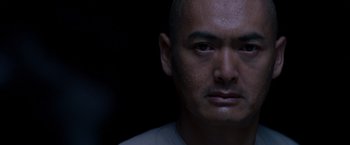 Movie still from “Crouching Tiger, Hidden Dragon” (2000), directed by Ang Lee – A person's face in the dark; Close Up shot, Low angle