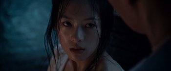 Movie still from “Crouching Tiger, Hidden Dragon” (2000), directed by Ang Lee – A young woman with wet hair looking at the camera; Close Up shot, Low angle