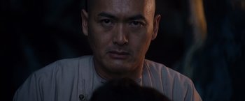 Movie still from “Crouching Tiger, Hidden Dragon” (2000), directed by Ang Lee – A man with a bald head is looking at the camera; Close Up shot, Low angle