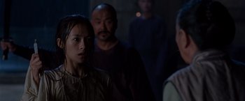 Movie still from “Crouching Tiger, Hidden Dragon” (2000), directed by Ang Lee – A group of people standing in a dark room; Close Up shot, Over the shoulder angle