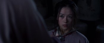 Movie still from “Crouching Tiger, Hidden Dragon” (2000), directed by Ang Lee – A young woman is looking into the camera; Close Up shot, Over the shoulder angle