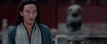 Movie still from “Crouching Tiger, Hidden Dragon” (2000), directed by Ang Lee – A man with long black hair wearing a robe; Close Up shot, Low angle