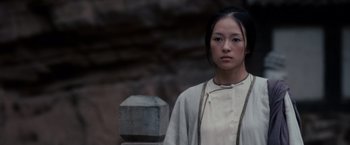 Movie still from “Crouching Tiger, Hidden Dragon” (2000), directed by Ang Lee – A woman standing in front of a stone wall; Close Up shot, Low angle