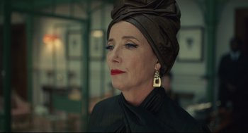 Movie still from “Cruella” (2021), directed by Craig Gillespie – A person wearing a turban; Close Up shot, Low angle