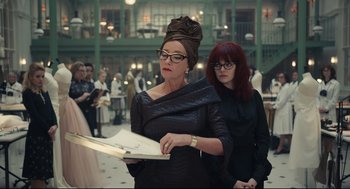 Movie still from “Cruella” (2021), directed by Craig Gillespie – A woman in a black dress and a woman in a black dress; Medium shot, Over the shoulder angle