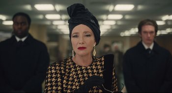 Movie still from “Cruella” (2021), directed by Craig Gillespie – A woman in a black and white outfit with a black turban; Close Up shot, Over the shoulder angle