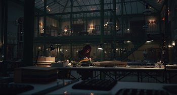 Movie still from “Cruella” (2021), directed by Craig Gillespie – A person working in a kitchen at night; Extreme Wide shot, Low angle