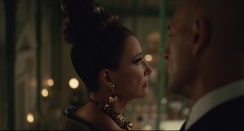 Movie still from “Cruella” (2021), directed by Craig Gillespie – A person wearing a necklace; Close Up shot, Over the shoulder angle
