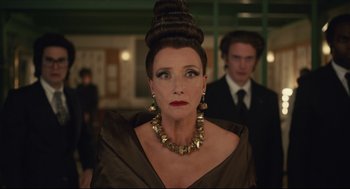 Movie still from “Cruella” (2021), directed by Craig Gillespie – A woman in a dress and a man in a black suit; Close Up shot, Over the shoulder angle