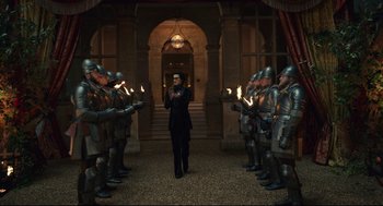 Movie still from “Cruella” (2021), directed by Craig Gillespie – A group of men are standing in front of each other; Wide shot, High angle