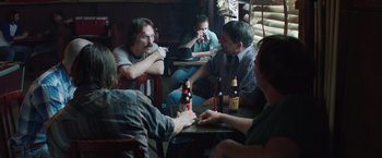 Movie still from “Dallas Buyers Club” (2013), directed by Jean-Marc Vallée – A group of men sitting around a table drinking beer; Medium shot, Over the shoulder angle