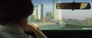 Movie still from “Dallas Buyers Club” (2013), directed by Jean-Marc Vallée – A woman driving a car on a city street; Close Up shot, Over the shoulder angle