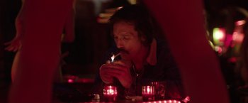 Movie still from “Dallas Buyers Club” (2013), directed by Jean-Marc Vallée – A man sitting at a table with a lit cigarette in his mouth; Close Up shot, Over the shoulder angle