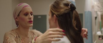 Movie still from “Dallas Buyers Club” (2013), directed by Jean-Marc Vallée – A woman looking in the mirror while a makeup artist looks on; Close Up shot, Over the shoulder angle