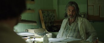 Movie still from “Dallas Buyers Club” (2013), directed by Jean-Marc Vallée – An older man sitting in front of a laptop computer; Medium shot, Low angle