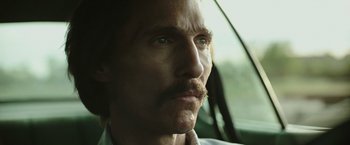 Movie still from “Dallas Buyers Club” (2013), directed by Jean-Marc Vallée – A person with a mustache in a car; Close Up shot, Low angle