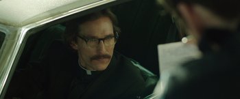 Movie still from “Dallas Buyers Club” (2013), directed by Jean-Marc Vallée – A man in a priest's outfit looking out of a car window; Close Up shot, Over the shoulder angle