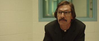 Movie still from “Dallas Buyers Club” (2013), directed by Jean-Marc Vallée – A man in a priest's outfit sitting in front of a window; Close Up shot, Low angle