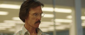Movie still from “Dallas Buyers Club” (2013), directed by Jean-Marc Vallée – A person wearing glasses and a plaid shirt; Close Up shot, Low angle