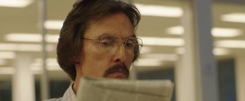 Movie still from “Dallas Buyers Club” (2013), directed by Jean-Marc Vallée – A man with glasses reading a newspaper; Close Up shot, Low angle