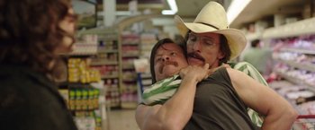 Movie still from “Dallas Buyers Club” (2013), directed by Jean-Marc Vallée – A man holding a baby in his arms in a grocery store; Close Up shot, Over the shoulder angle