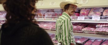 Movie still from “Dallas Buyers Club” (2013), directed by Jean-Marc Vallée – A man wearing a cowboy hat in front of a meat display; Medium shot, Over the shoulder angle