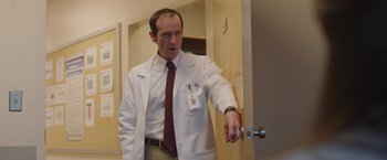 Movie still from “Dallas Buyers Club” (2013), directed by Jean-Marc Vallée – A man in a white lab coat and a red tie; Medium shot, Low angle