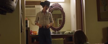 Movie still from “Dallas Buyers Club” (2013), directed by Jean-Marc Vallée – A man wearing a cowboy hat in front of a bathroom mirror; Medium shot, Over the shoulder angle