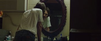 Movie still from “Dallas Buyers Club” (2013), directed by Jean-Marc Vallée – A man looking at himself in the mirror in a bathroom; Medium shot, Over the shoulder angle