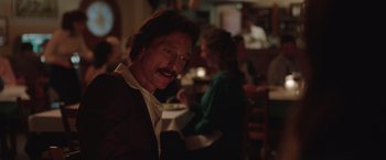Movie still from “Dallas Buyers Club” (2013), directed by Jean-Marc Vallée – A man sitting at a table in front of other people; Close Up shot, Over the shoulder angle