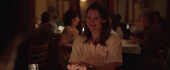 Movie still from “Dallas Buyers Club” (2013), directed by Jean-Marc Vallée – A woman sitting at a table in front of a window; Medium shot, Over the shoulder angle