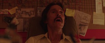 Movie still from “Dallas Buyers Club” (2013), directed by Jean-Marc Vallée – A person sitting on a couch; Close Up shot, Low angle