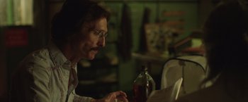 Movie still from “Dallas Buyers Club” (2013), directed by Jean-Marc Vallée – A man sitting at a table looking at papers; Close Up shot, Over the shoulder angle