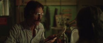 Movie still from “Dallas Buyers Club” (2013), directed by Jean-Marc Vallée – A man with glasses is looking at a paper; Close Up shot, Over the shoulder angle