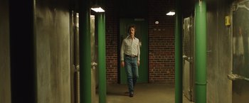 Movie still from “Dallas Buyers Club” (2013), directed by Jean-Marc Vallée – A man is walking down the hallway of a building; Wide shot, Low angle