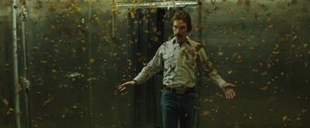 Movie still from “Dallas Buyers Club” (2013), directed by Jean-Marc Vallée – A man standing in front of an elevator with falling leaves on the floor; Medium shot, Low angle