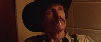 Movie still from “Dallas Buyers Club” (2013), directed by Jean-Marc Vallée – A person wearing a cowboy hat smoking a cigarette; Close Up shot, Low angle