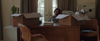 Movie still from “Dallas Buyers Club” (2013), directed by Jean-Marc Vallée – A man sitting at a desk in front of a bunch of boxes; Medium shot, High angle