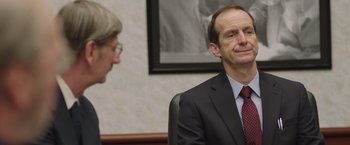 Movie still from “Dallas Buyers Club” (2013), directed by Jean-Marc Vallée – A man in a suit and tie sitting next to another man; Close Up shot, Over the shoulder angle