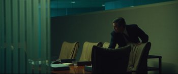 Movie still from “Dark Waters” (2019), directed by Todd Haynes – A man sitting at a table in a conference room; Medium shot, Over the shoulder angle