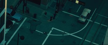 Movie still from “Dark Waters” (2019), directed by Todd Haynes – People are walking on the sidewalk at night time; Extreme Wide shot, Overhead angle