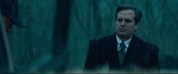 Movie still from “Dark Waters” (2019), directed by Todd Haynes – A man wearing a suit and tie standing in the rain; Close Up shot, Low angle