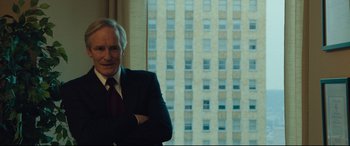 Movie still from “Dark Waters” (2019), directed by Todd Haynes – A man in a suit standing in front of a window; Medium shot, Over the shoulder angle