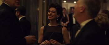 Movie still from “Dark Waters” (2019), directed by Todd Haynes – A woman in a black dress smiling for the camera; Close Up shot, Over the shoulder angle