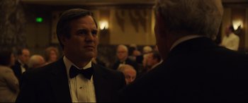Movie still from “Dark Waters” (2019), directed by Todd Haynes – A man in a suit and a bow tie standing next to another man in a suit and a bow tie; Close Up shot, Over the shoulder angle