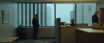 Movie still from “Dark Waters” (2019), directed by Todd Haynes – A man and a woman in an office looking out a window; Extreme Wide shot, Over the shoulder angle