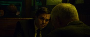 Movie still from “Dark Waters” (2019), directed by Todd Haynes – A man wearing a suit and tie talking to another man in a suit and tie; Close Up shot, Over the shoulder angle